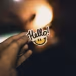 person holding Hello! sticker